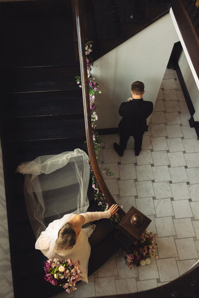 A photo taken from above a staircase at Venue3Two depicts a first look at a Grand Rapids wedding